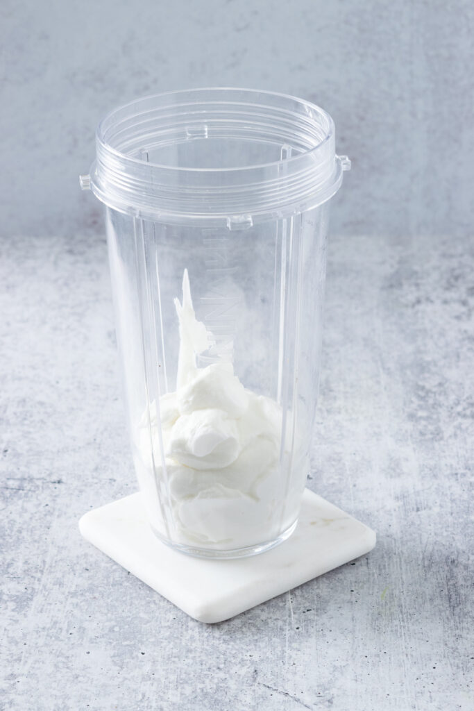 Yogurt added to a blender cup.