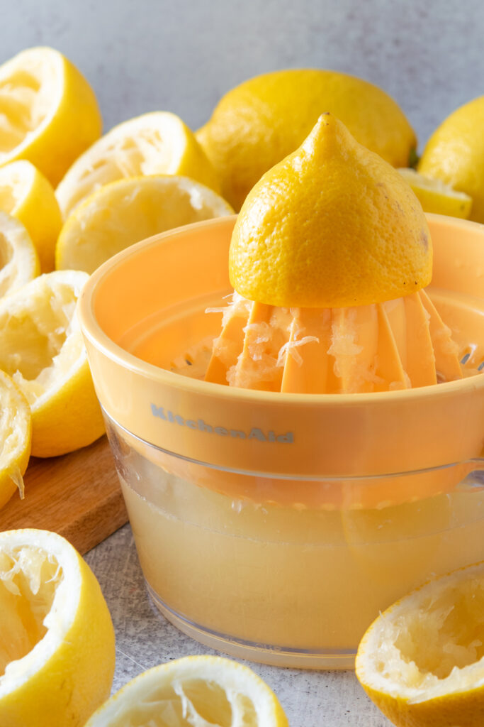 Squeezing eight large lemons by hand to make a full gallon of homemade lemonade.