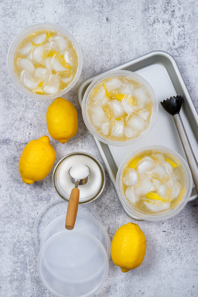 Cold water being poured into the lemonade drinks.