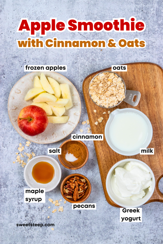 Overhead image showing all the ingredients needed to make an apple smoothie, in small bowls and measuring cups. There are sliced frozen apples, oats. milk. Greek yogurt, and small bowls with cinnamon and salt, maple syrup, and pecans. The image has text overlay that reads, "Apple Smoothie with Cinnamon and Oats."