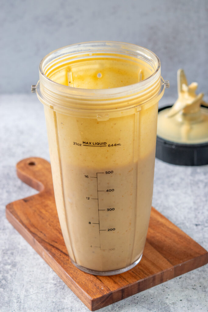 A pumpkin smoothie that's been blended until smooth still in a blender cup.