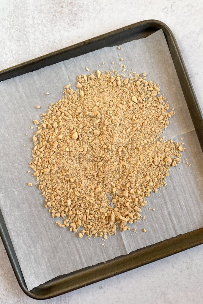 Crumble topping spread on a baking sheet.