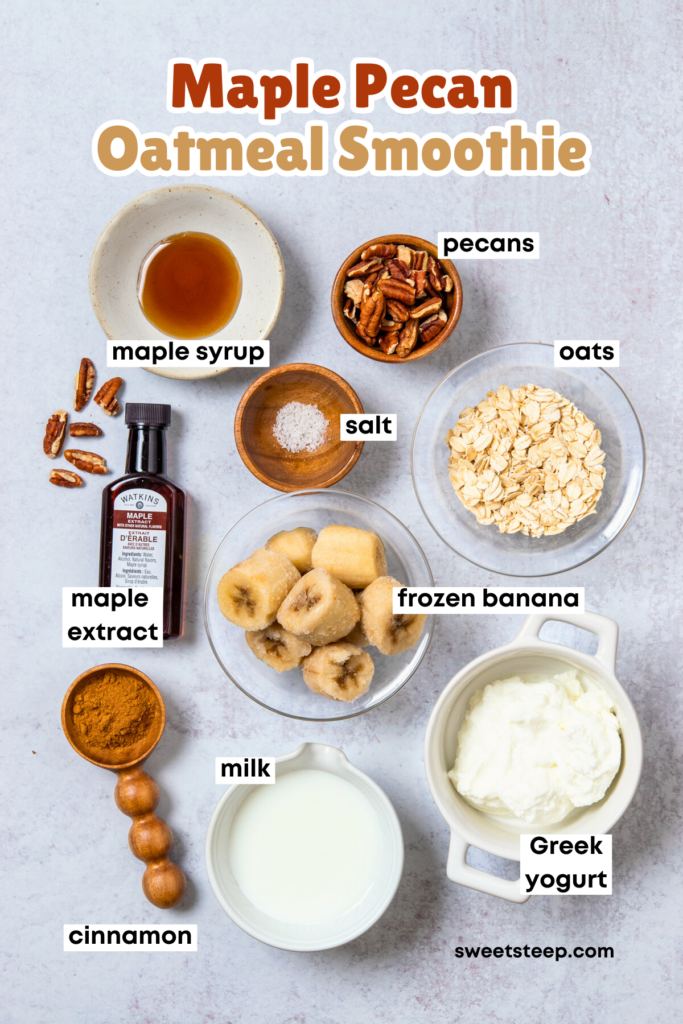 Overhead picture of all the ingredients needed to make a maple pecan oatmeal smoothie, including maple syrup, maple extract, pecans, oats, frozen banana, cinnamon, Greek yogurt and milk.