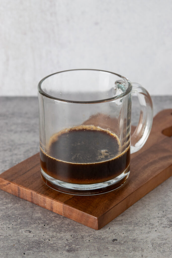 Brewed espresso poured into mug with pumpkin syrup.