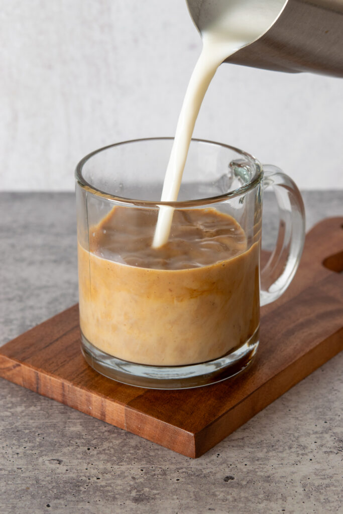 Steamed milk being poured into espresso to make a latte.
