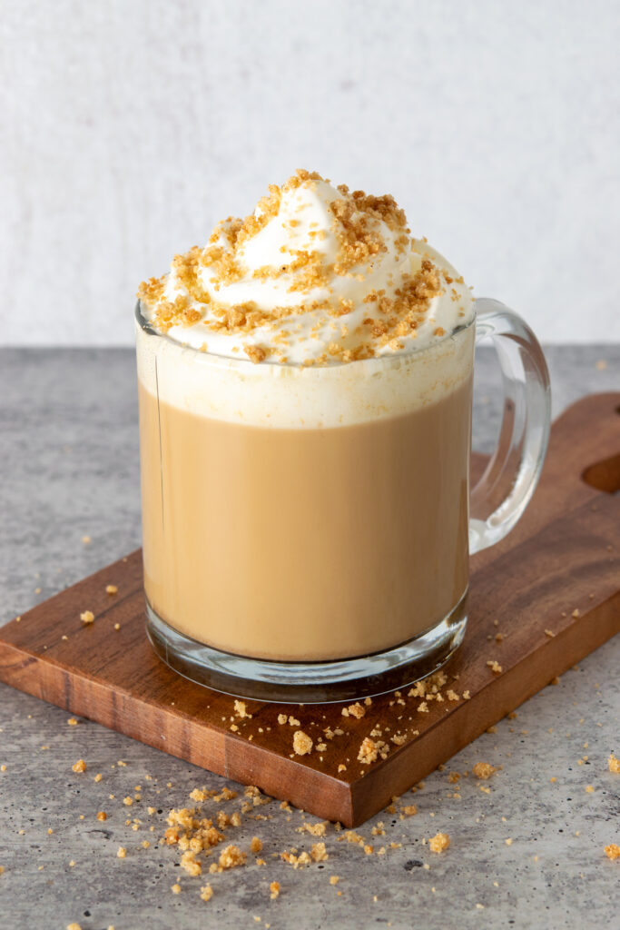 Pie crust crumbles are sprinkled all over the whipped cream to make a pumpkin pie latte.
