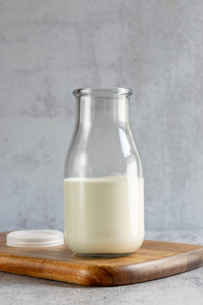 Pouring cream into a bottle.