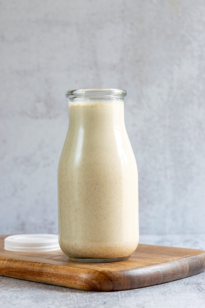 Finished pumpkin spice creamer in a bottle, ready to add to coffee.