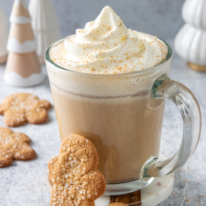 Homemade gingerbread chai latte served with gingerbread cookies.