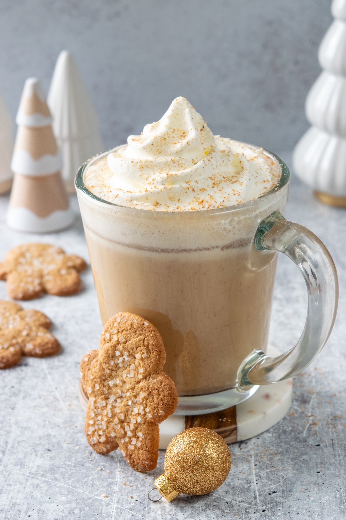 Homemade gingerbread chai latte served with gingerbread cookies.